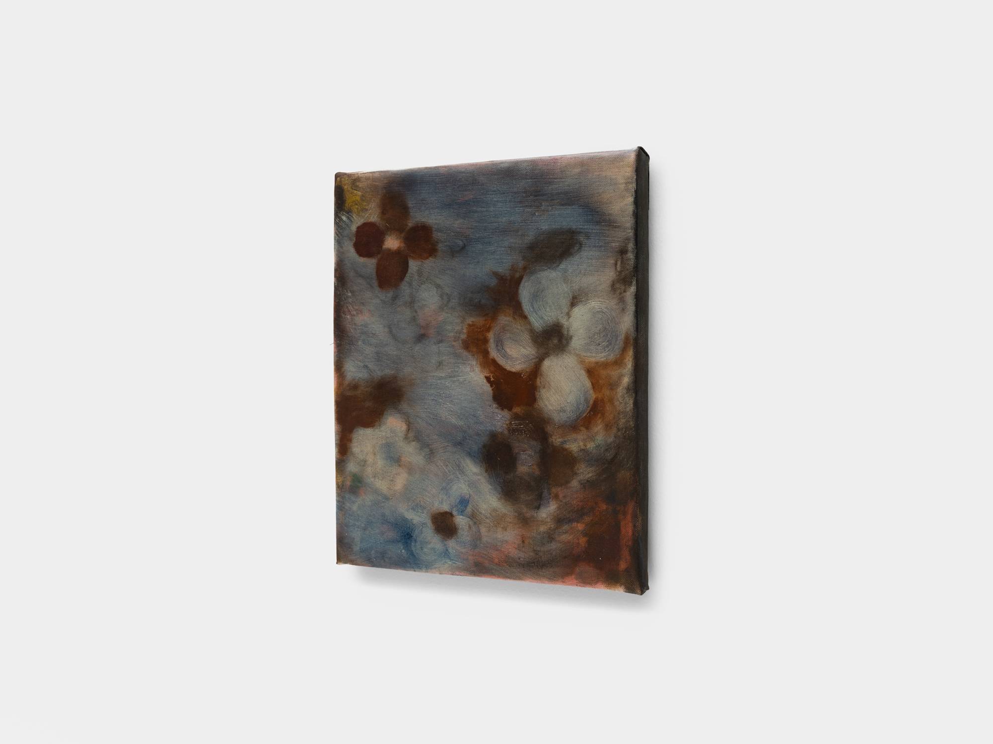 A side angle view of a small square abstract painting of flowers in hues of blue and brown.