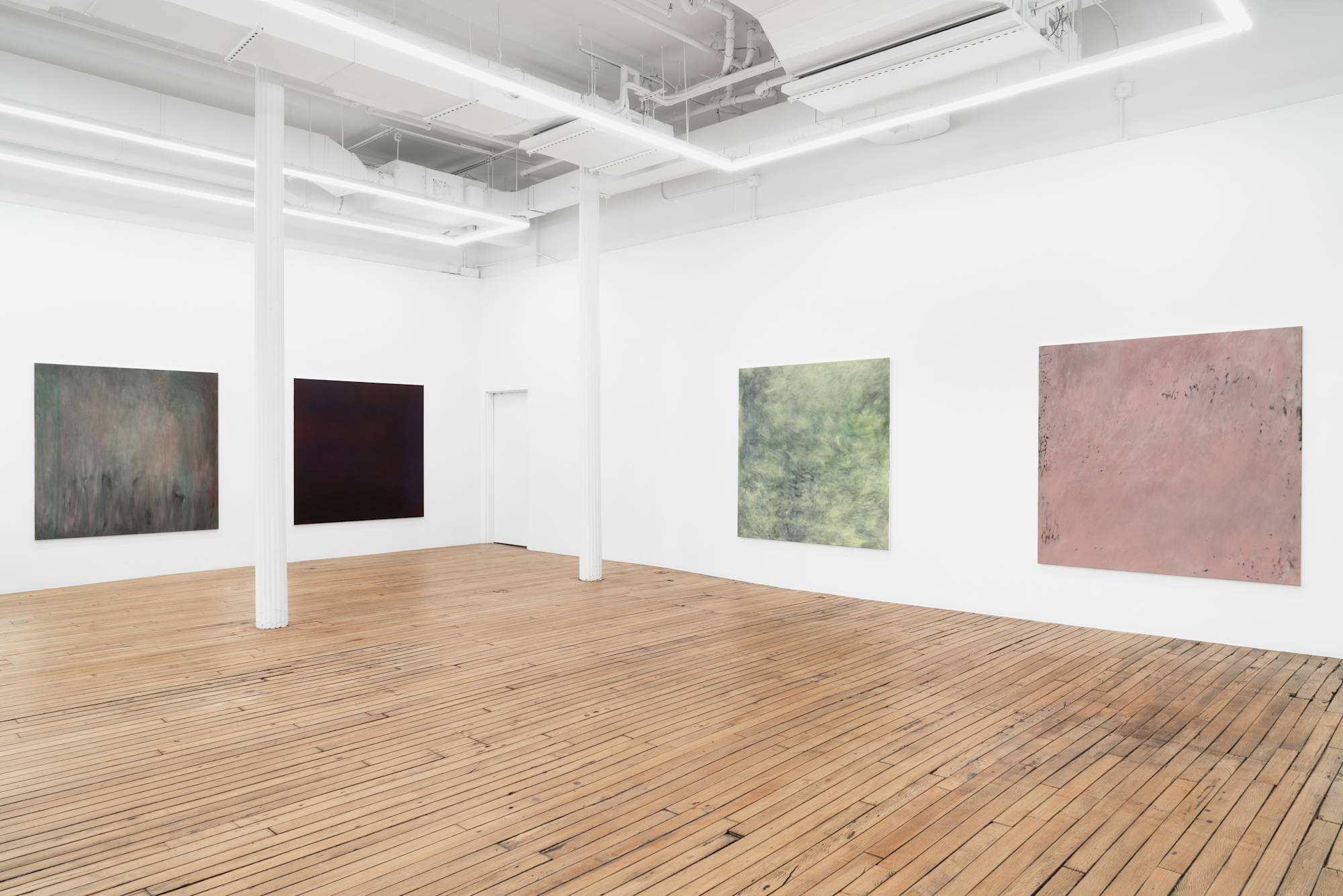 Four large abstract paintings full of gestural marks spaced evenly throughout a brightly lit gallery space.
