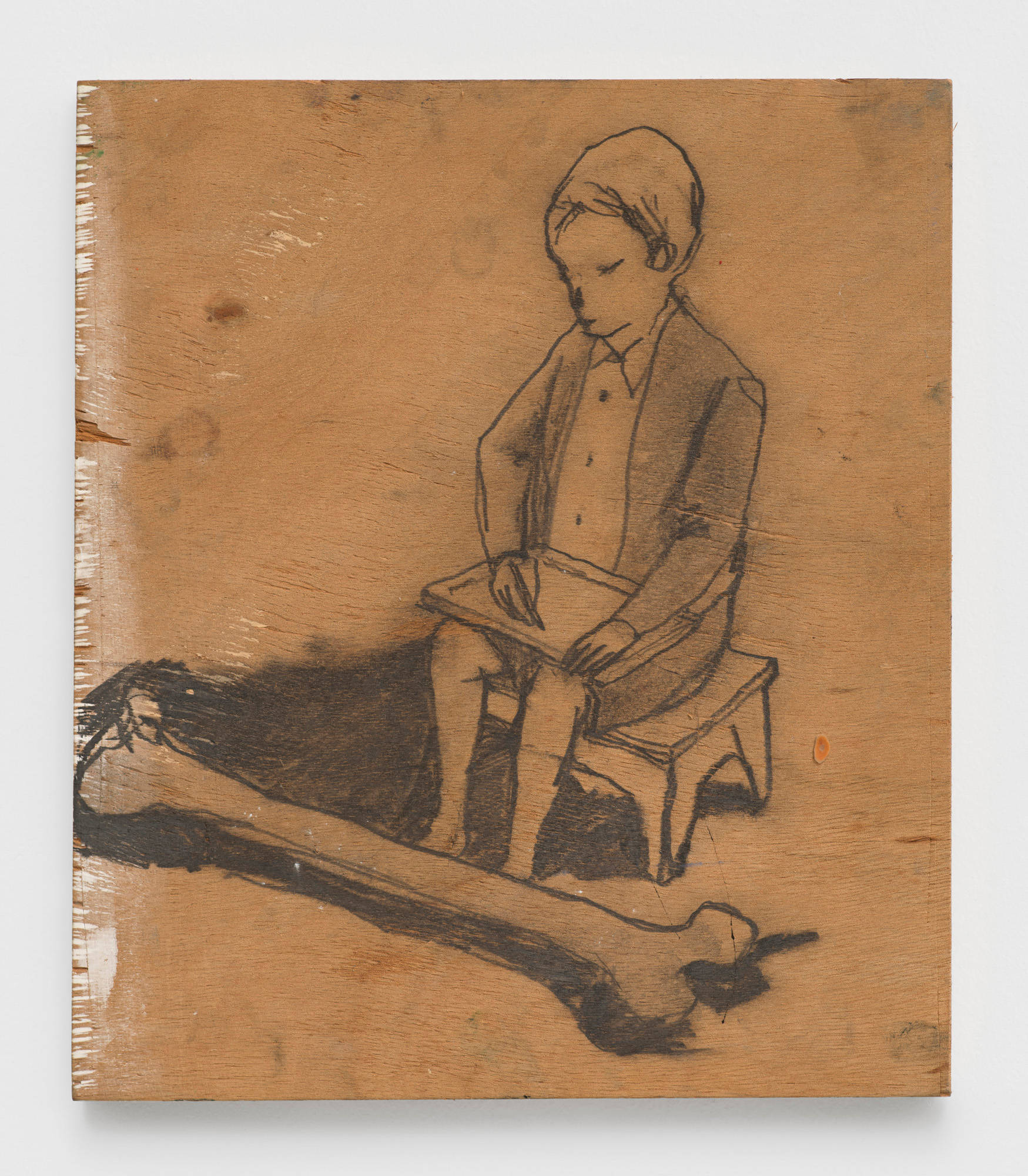 A small drawing utilizing graphite on wood depicts a child sitting on a stool drawing in his lap. A disproportionately large bone sits at his feet.
