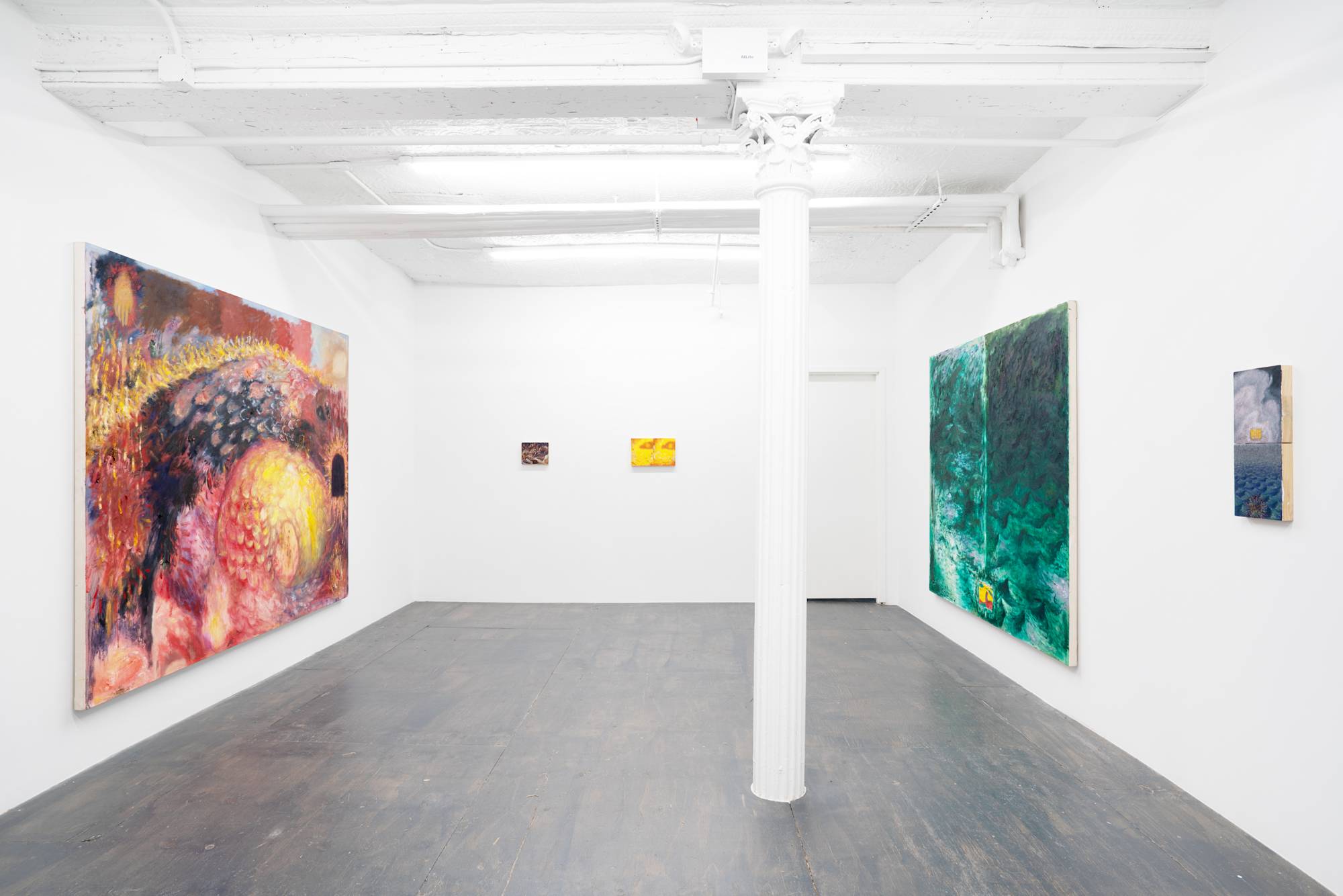 View of a gallery with white walls and ceiling, grey plywood floors, and a central white column. Five paintings by Thiang Uk hang on the walls of the gallery.