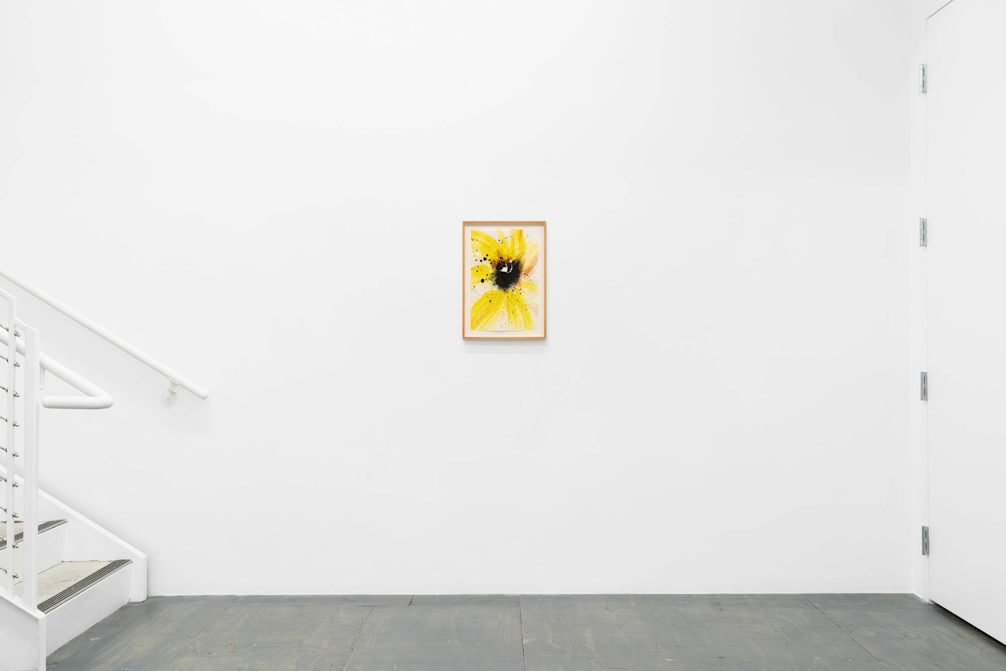 A small ink painting of a close-up yellow and black sunflower, mounted on a white wall.