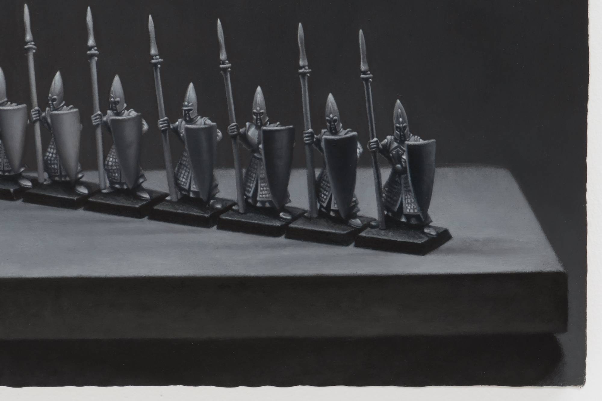 Detail of Ian Miyamura painting depicting seven unpainted Warhammer spearmen figures on a small tabletop against a black background.