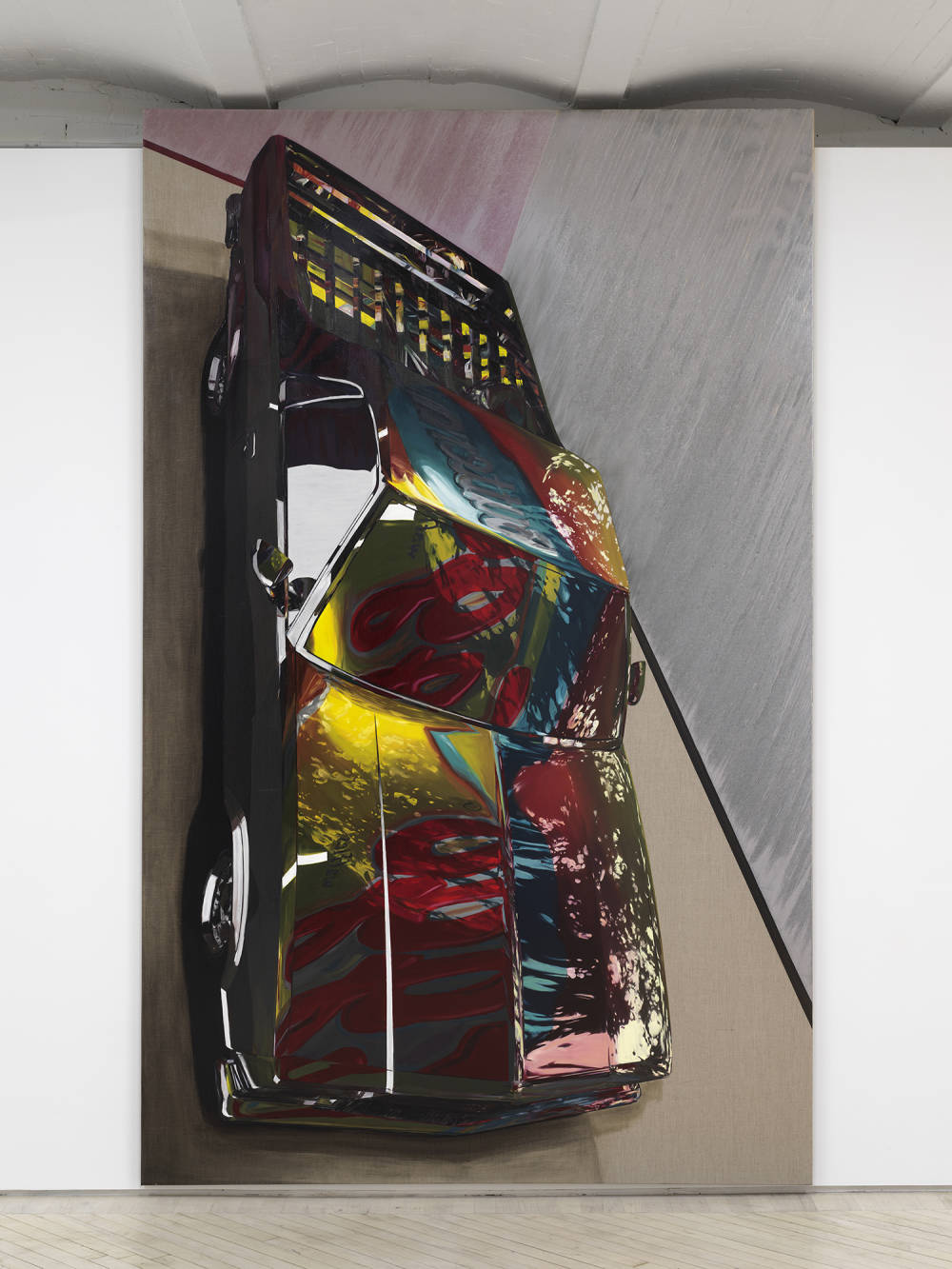 Image of a painting by Tom Holmes that shows a black El Camino car turned vertical that almost touches the ceiling. In the paint of the El Camino you can see a faint reflection of an Eggo waffles box.