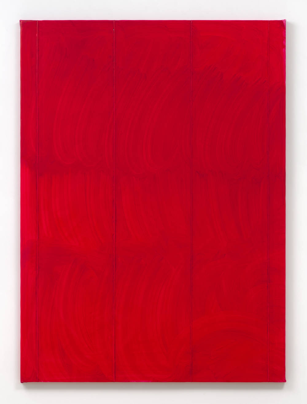 A large vertical painting. The painting is a red monochrome. The surface is brushy. 