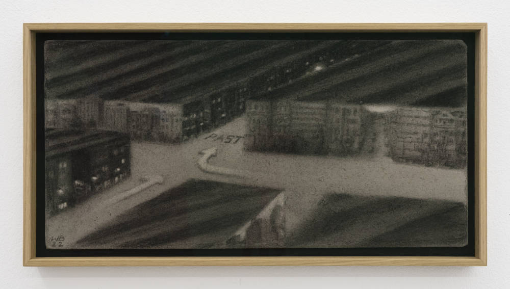 Image of a drawing by Wojciech Bakowski, executed in charcoal on gray board, framed in a blonde wood frame, showing a dream like sequence of blocks of apartment buildings and roads running through them.