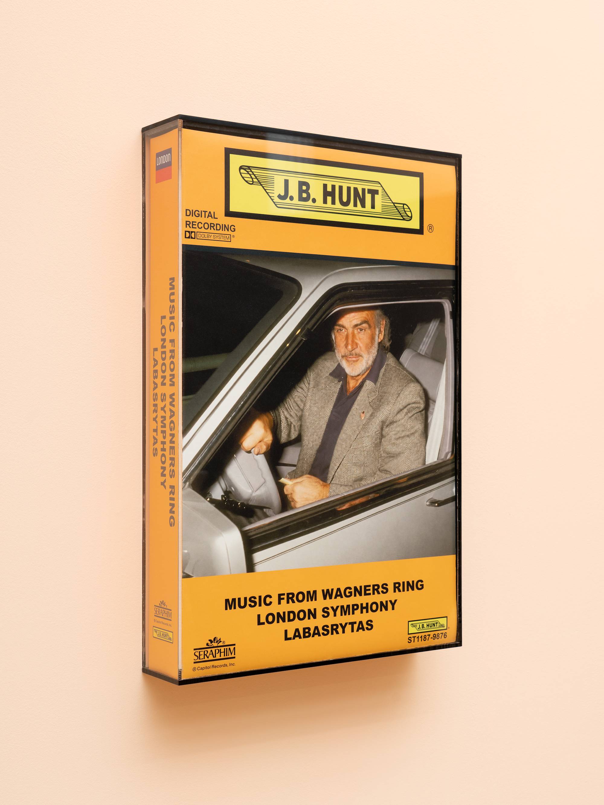 Oversized audio cassette case featuring an image of a Sean Connery driving a car.