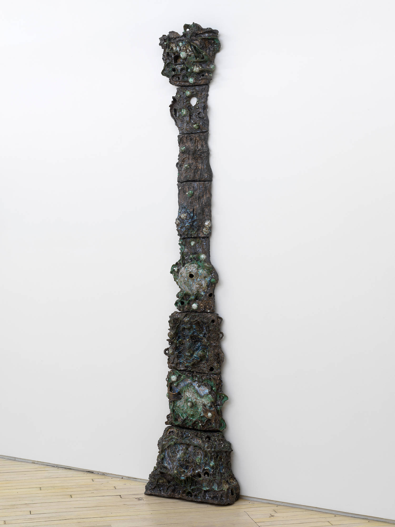 A tower of abstract ceramic sculptures installed in the shape of an expanding column.