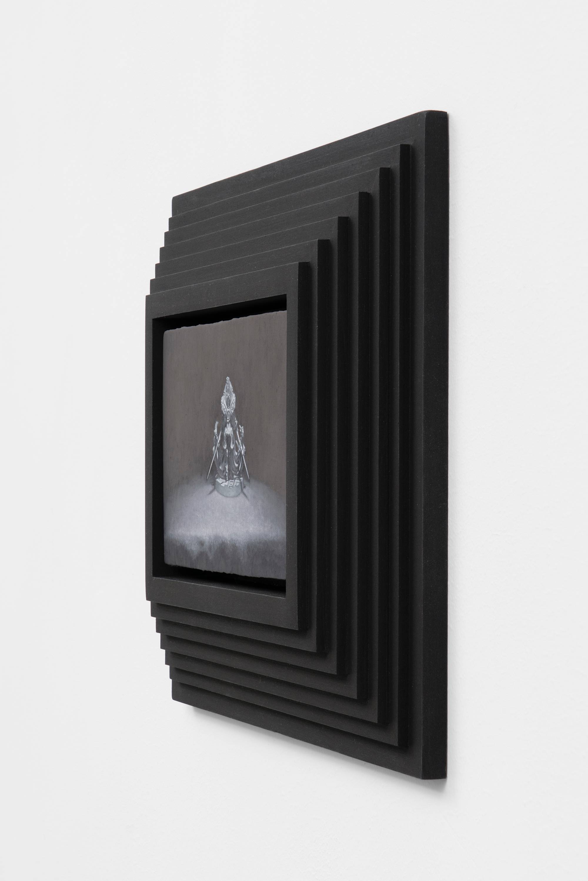 Detail of a painting featuring a warhammer model posed against a black background in a custom, black, tiered, pyramid frame fabricated by the artist.