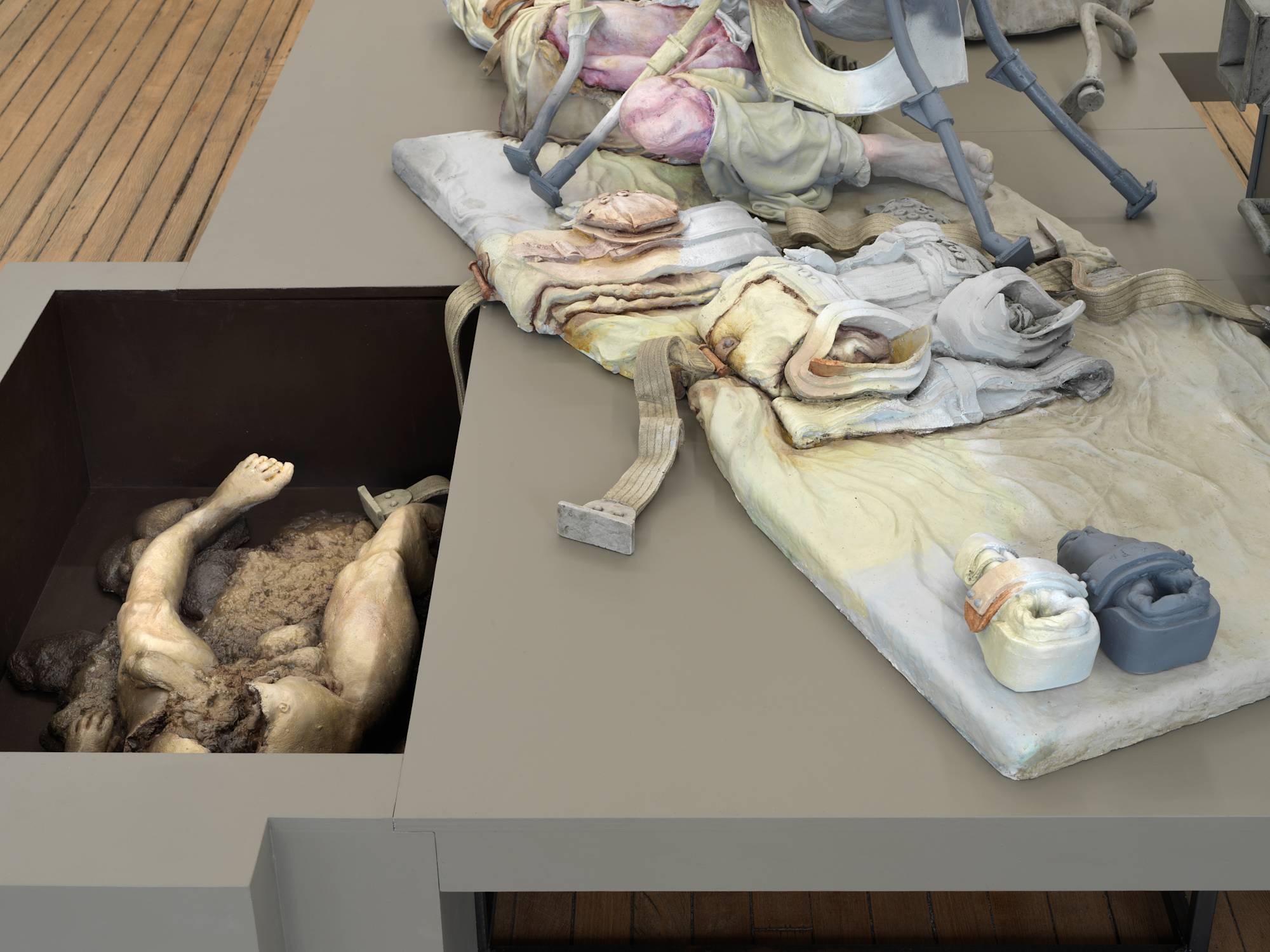 Close up image of a sculpture depicting abstracted human forms and devices.