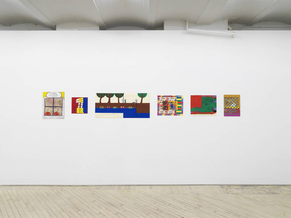 In a gallery space, a series of small works on paper are installed close together on a white wall. The drawings are clustered in a group. The drawings depict abstracted, cartoon-like character scenes. The sizes of the paper vary in length and proportion. There are interior spaces and exterior spaces depicted. 