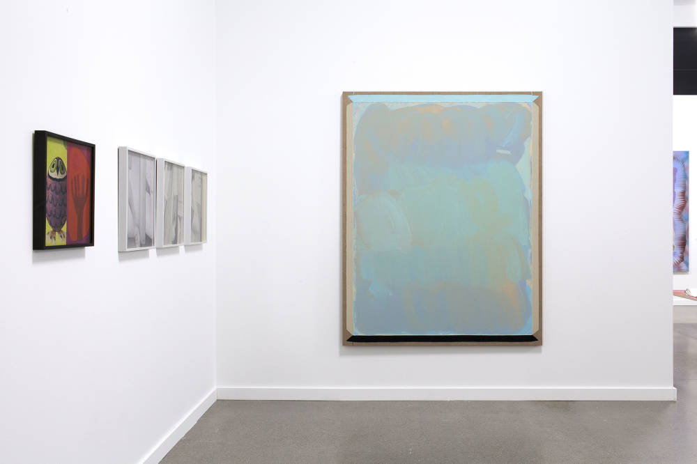 Installation view of Independent New York fair featuring artwork by Julia Rommel and Erica Baum.