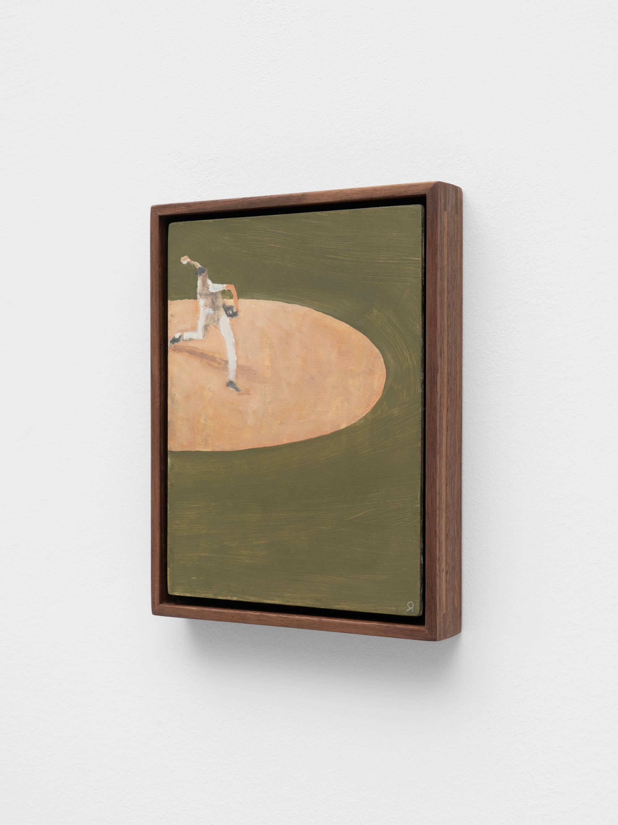 A painting depicts a stylized baseball pitcher in mid-throw on a pitcher's mound. The artwork is framed in dark wood and hangs against a white wall.