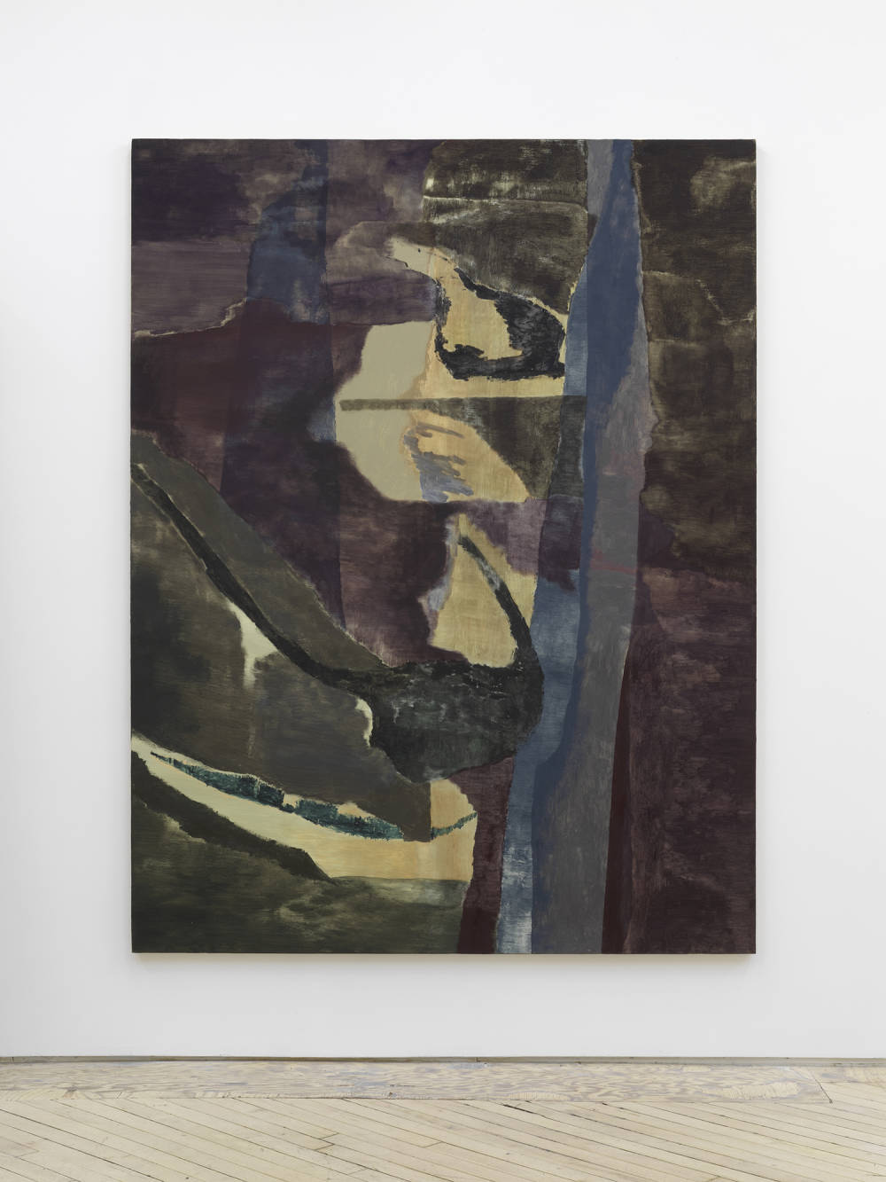 A large, gestural abstract painting rendered a range of muted earth tones installed on a gallery wall.