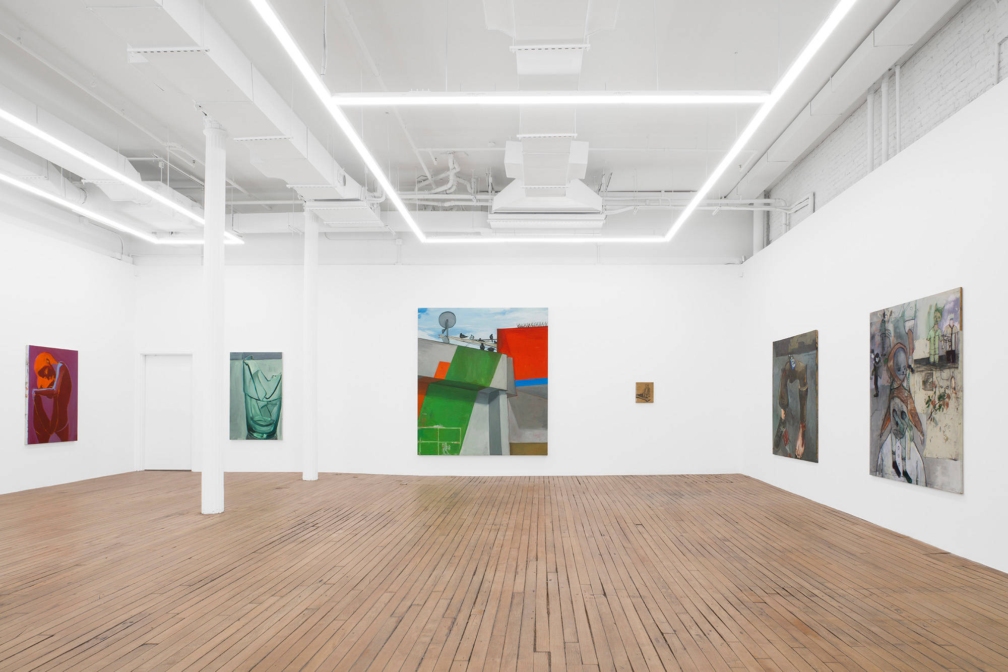 Five large paintings and one small drawing hang on the walls of a brightly lit gallery. They depict still lives and abstracted scenes from imagination.