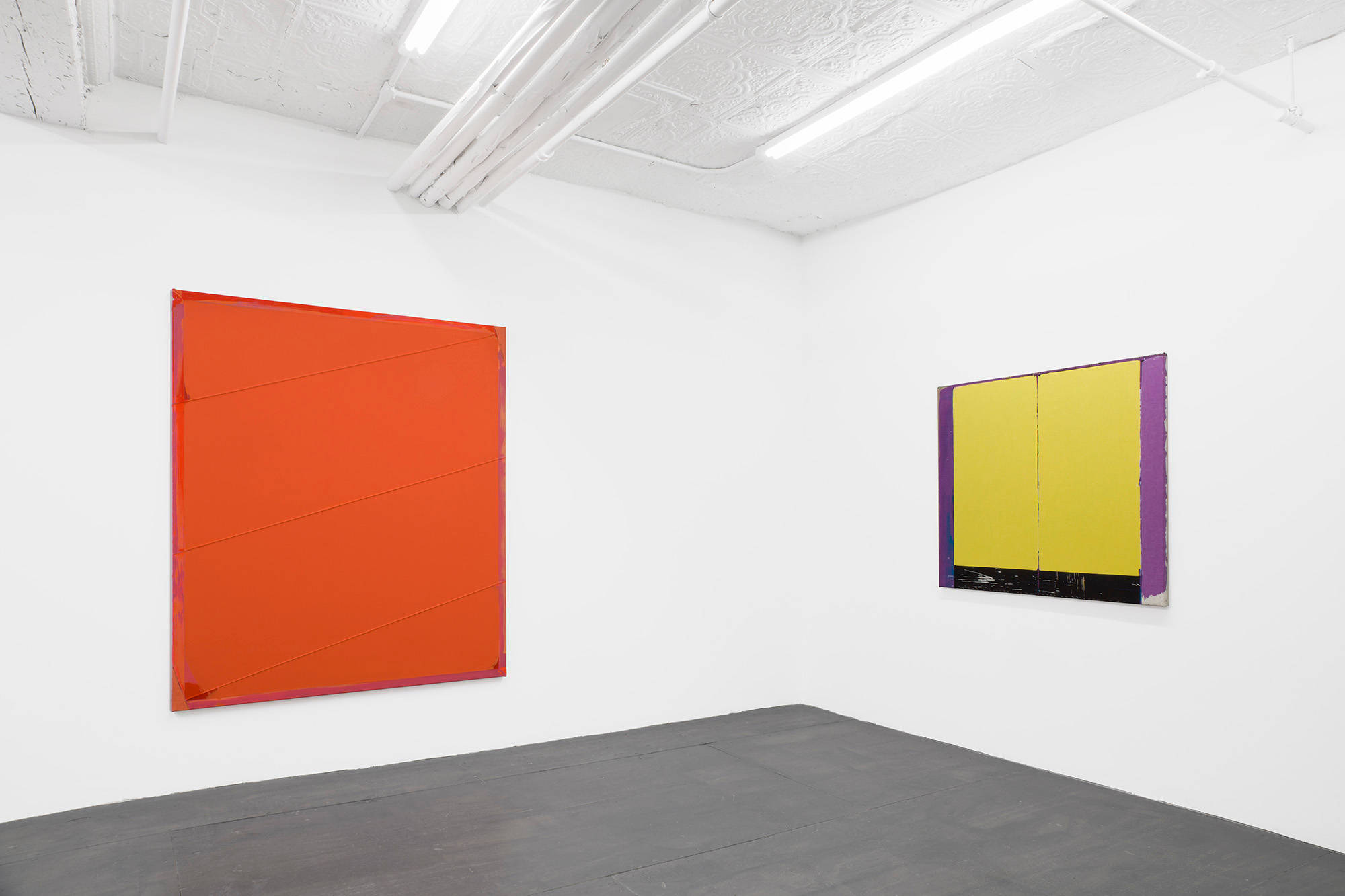 Two abstract paintings depicting primarily monochromatic fields of color predominantly in red and yellow.