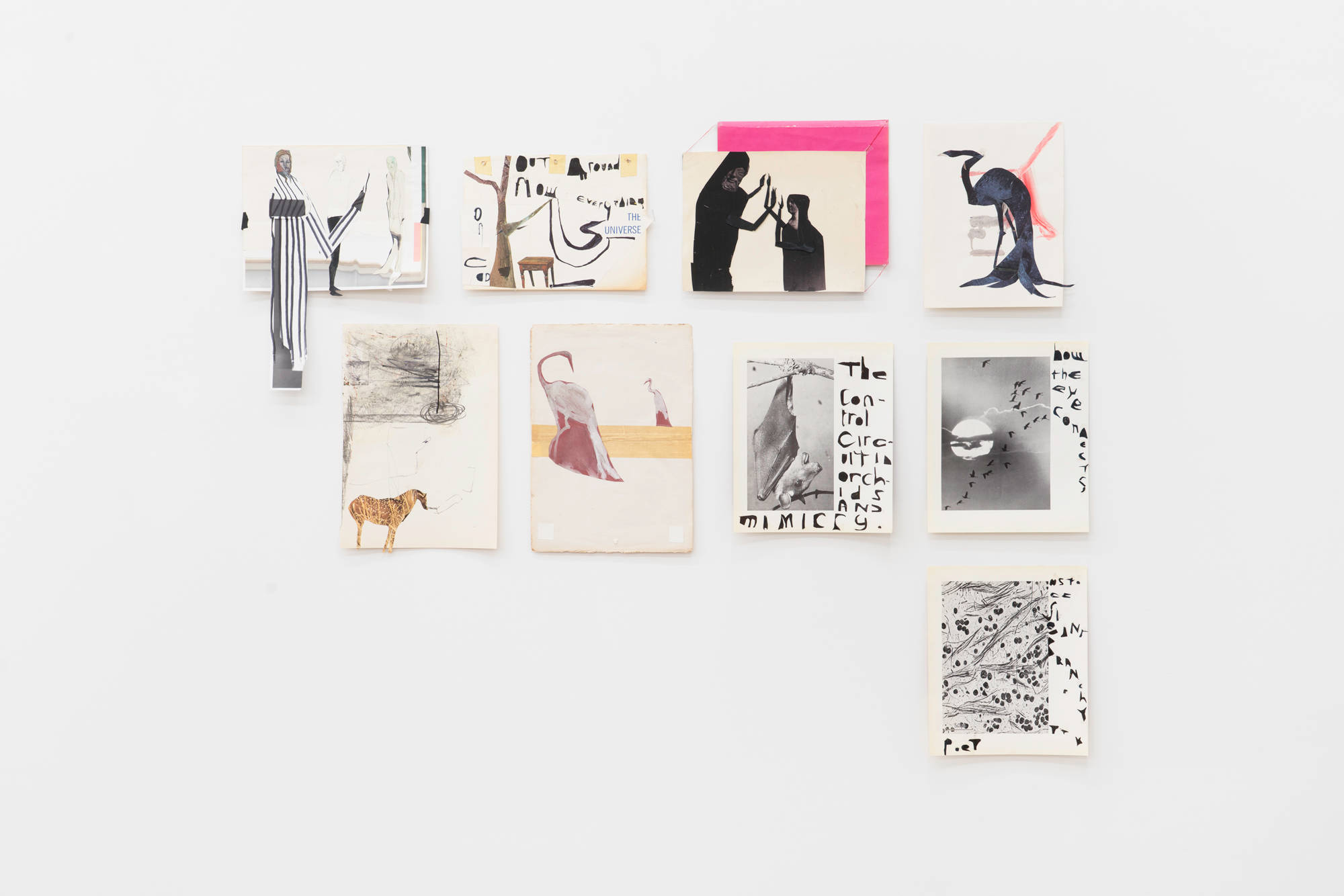 A group of nine collages by the artist Tom Thayer hang salon style on a white gallery wall.