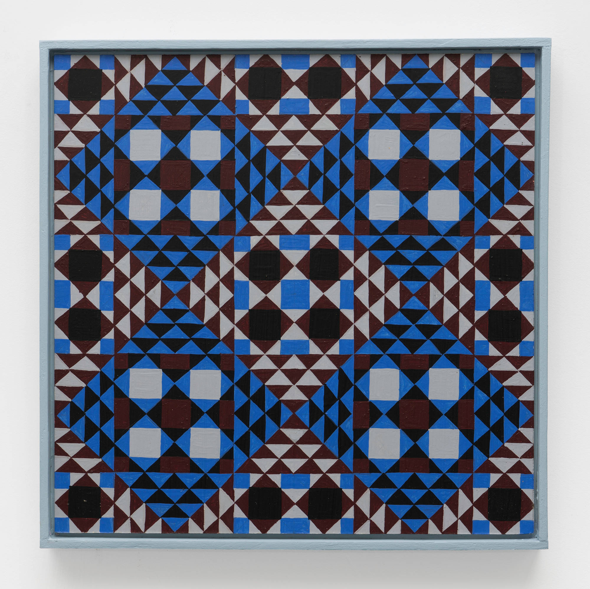 A colorful, symmetrical, geometric painting on board consisting of a pattern of repeating diamonds and triangles of maroon, grey, black and blue in a light blue artist frame.