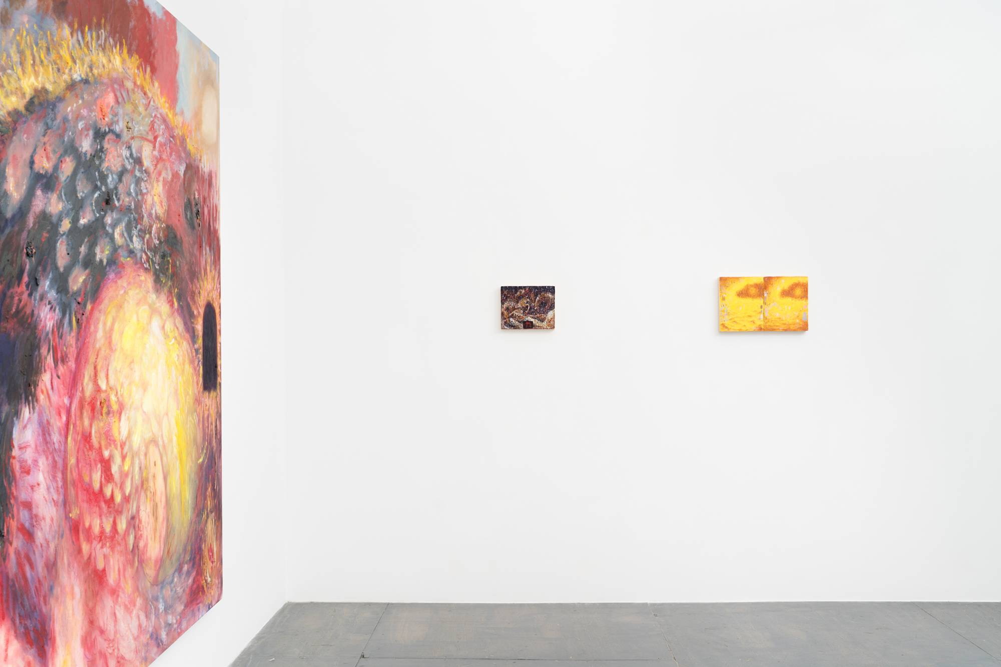 View of the southwest corner of the gallery. A large painting of a dragon hangs on the south wall extending out of frame. A small purple horse painting, and small yellow landscape diptych hang on the west wall.