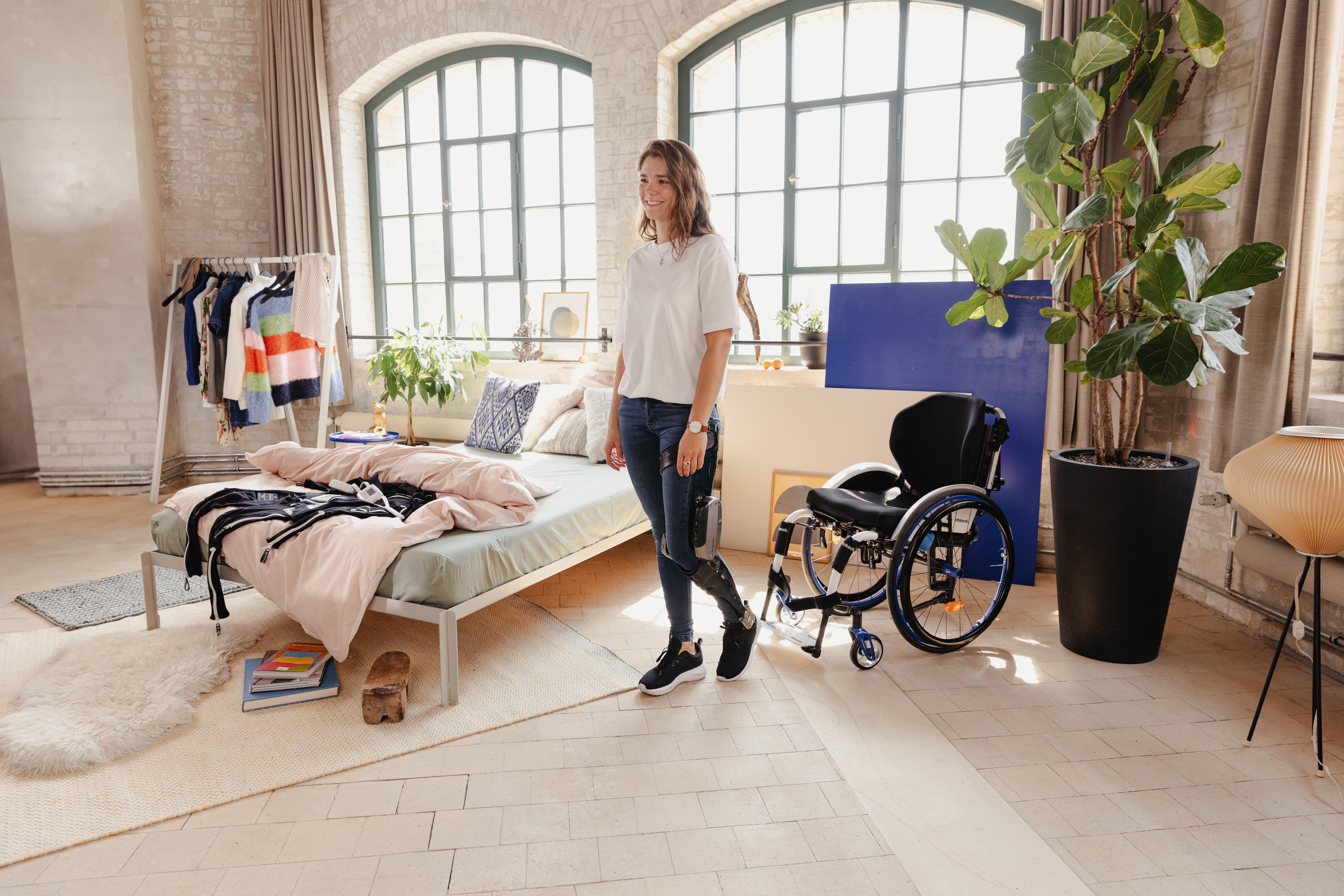 A girl standing next to a wheelchair