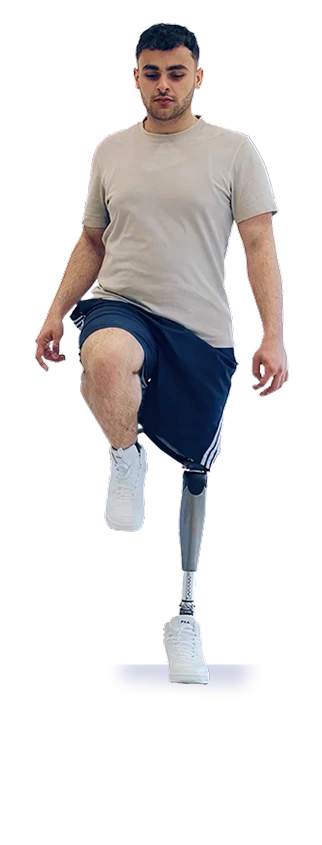 Person balancing on one leg while wearing a prosthetic limb against a white background.