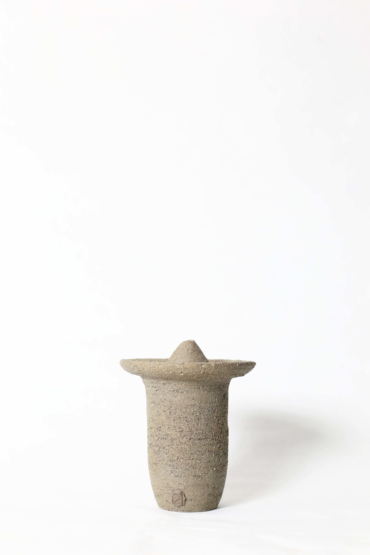 Ufo shaped gray ceramic vase on a white background I