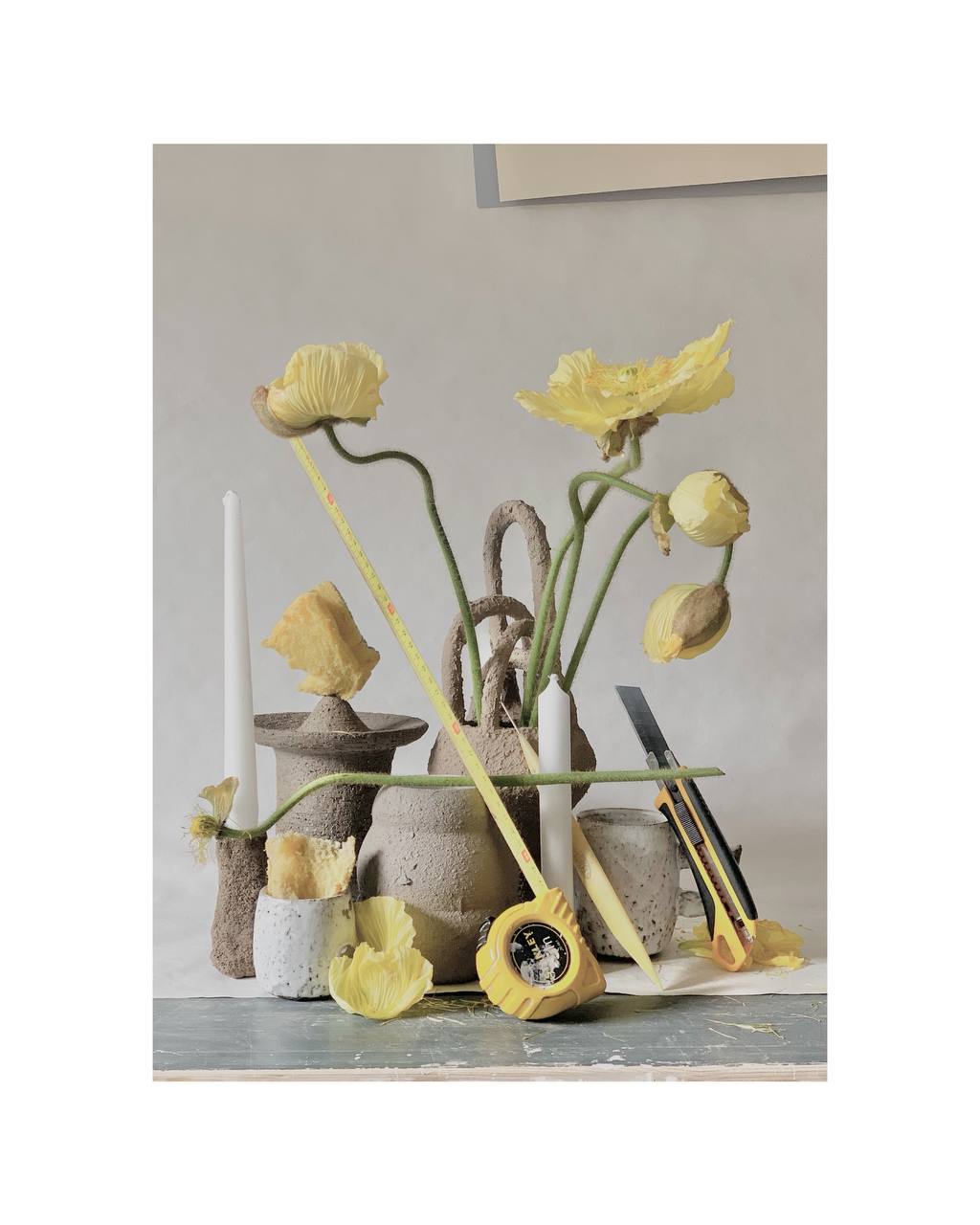 Still life of gray ceramic vases and different yellow objects
