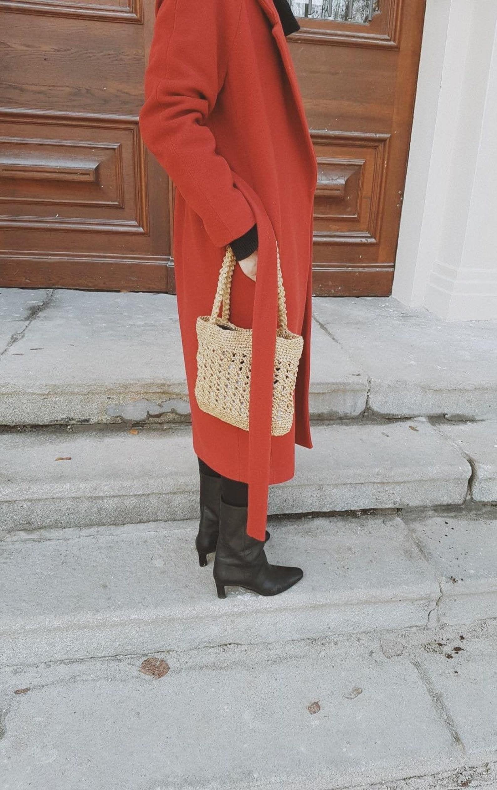 red coat and a basket bag
