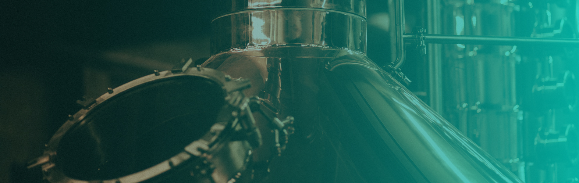 The top of a distillation tank with a turquoise gradient overlay on the right side of the image.