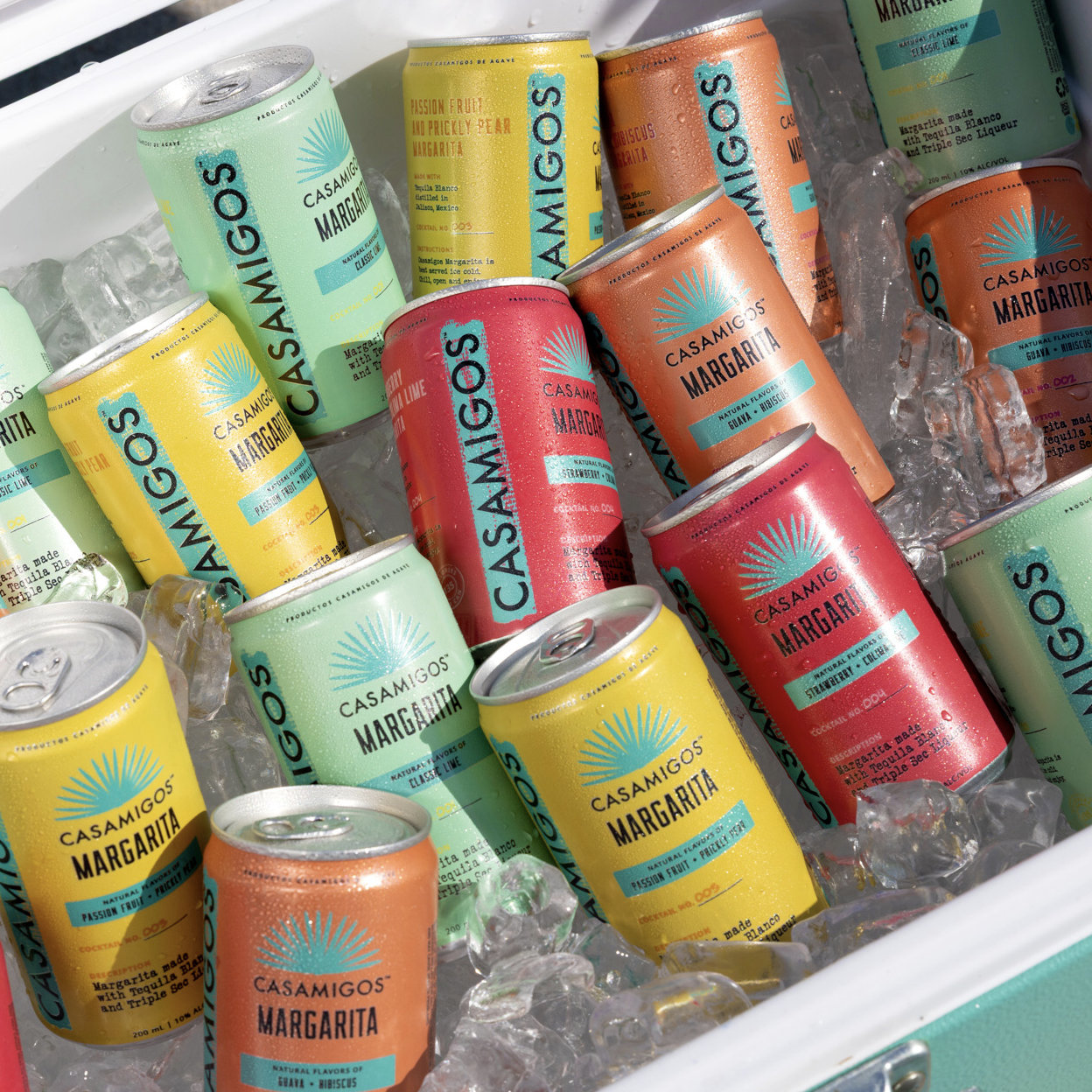 Ready-To-Drink canned Casamigos Margaritas in various flavors on ice.