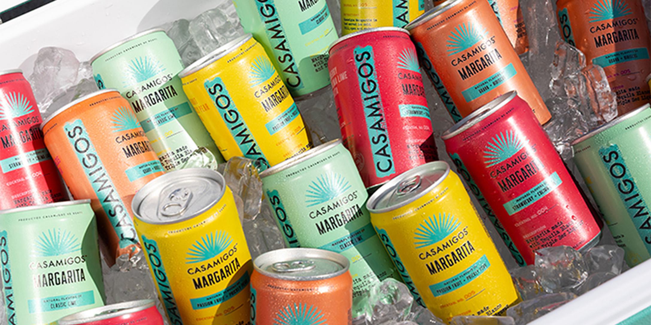 A variety of Casamigos Maragarita cans sitting on ice in a cooler