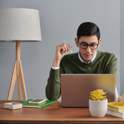 A student at a laptop studying.