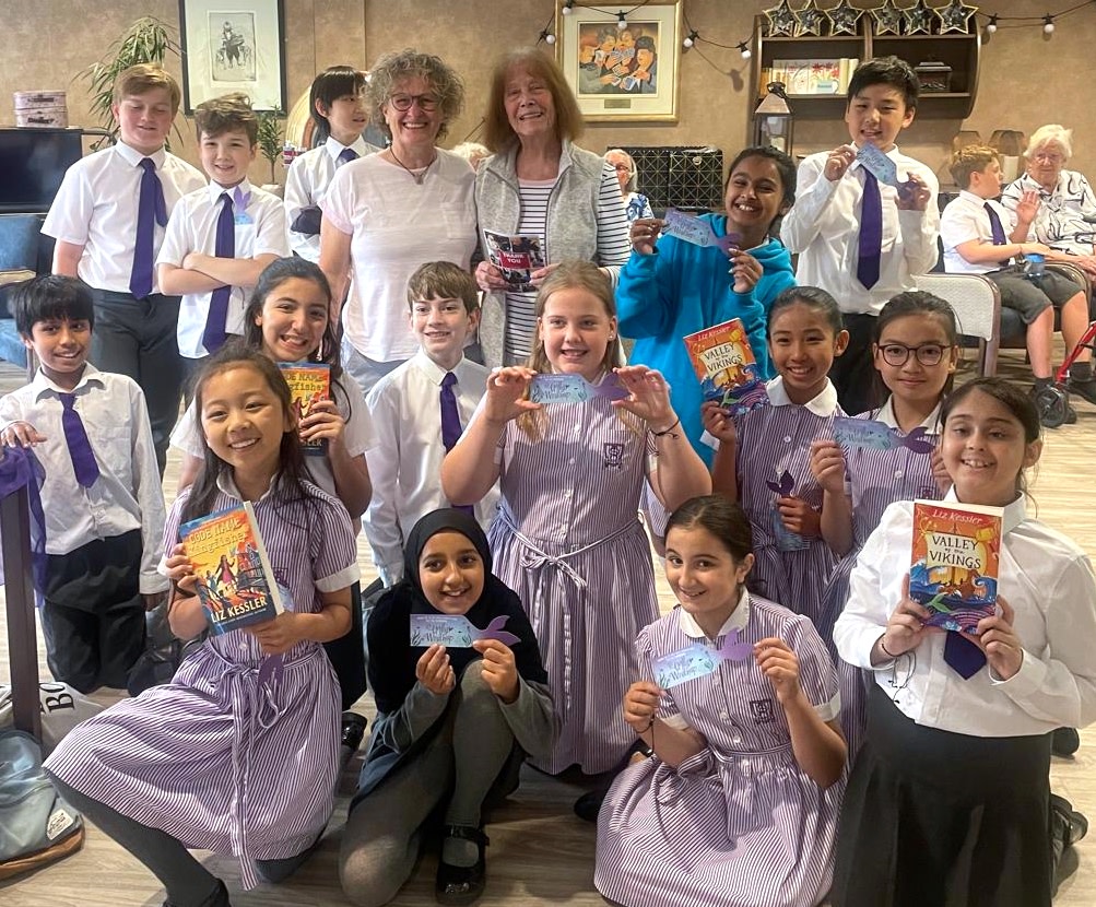 Pictured: Didsbury's Book Buddies welcome author Liz Kessler (centre, left) to Belong Morris Feinmann care village  
