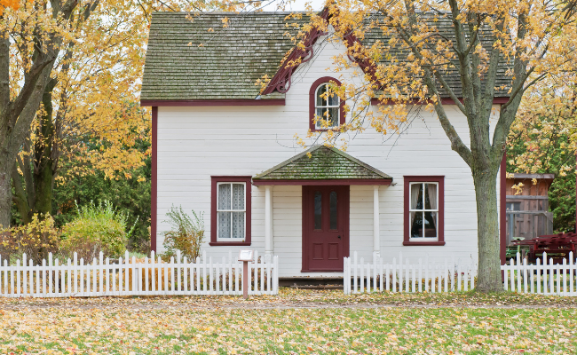 A cosy home surrounded by trees with changing colours.