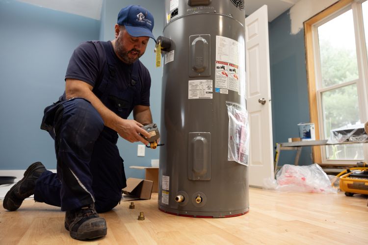 Technician working beside a residential water heater