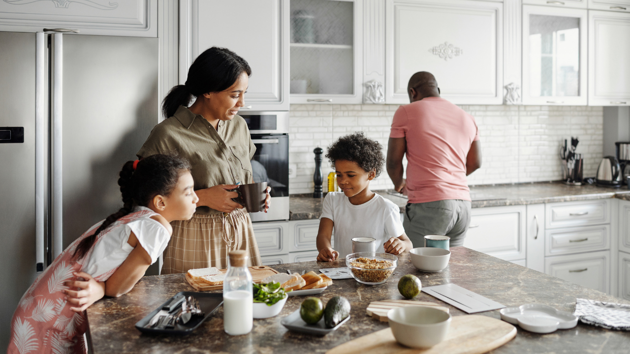 A family prepares a meal in their kitchen.