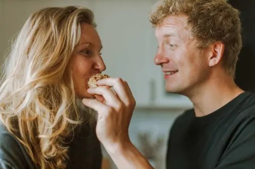 A couple eating food after discussing their beneficiary plans. 