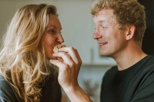 A couple eating food after discussing their beneficiary plans.