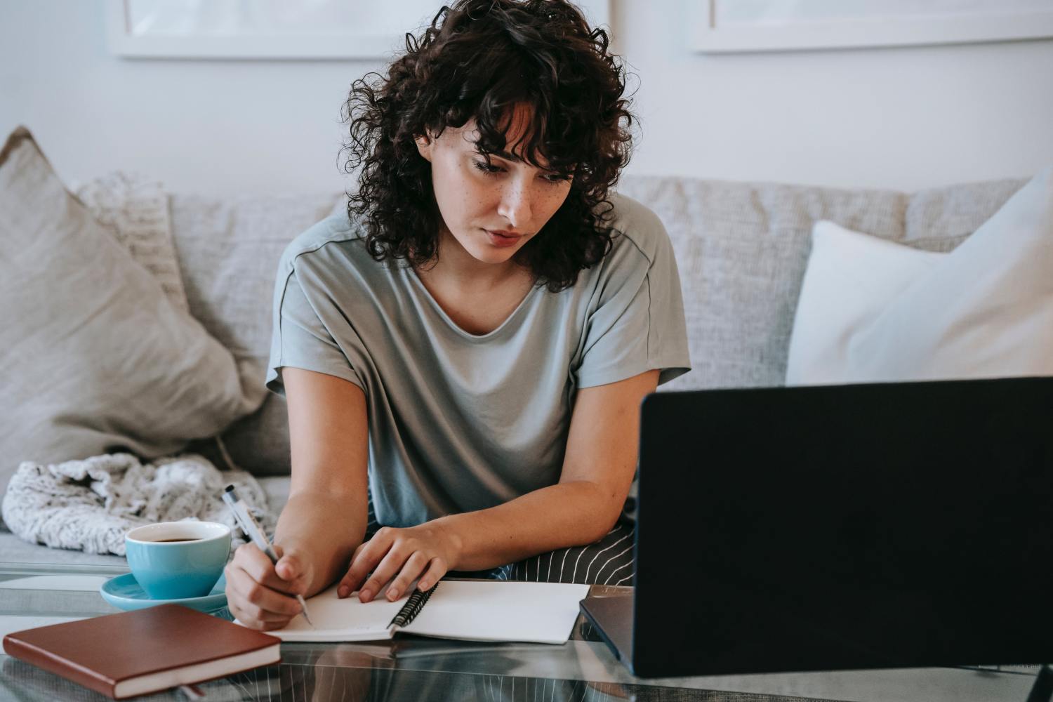 Woman on computer taking notes on life and disability insurance.