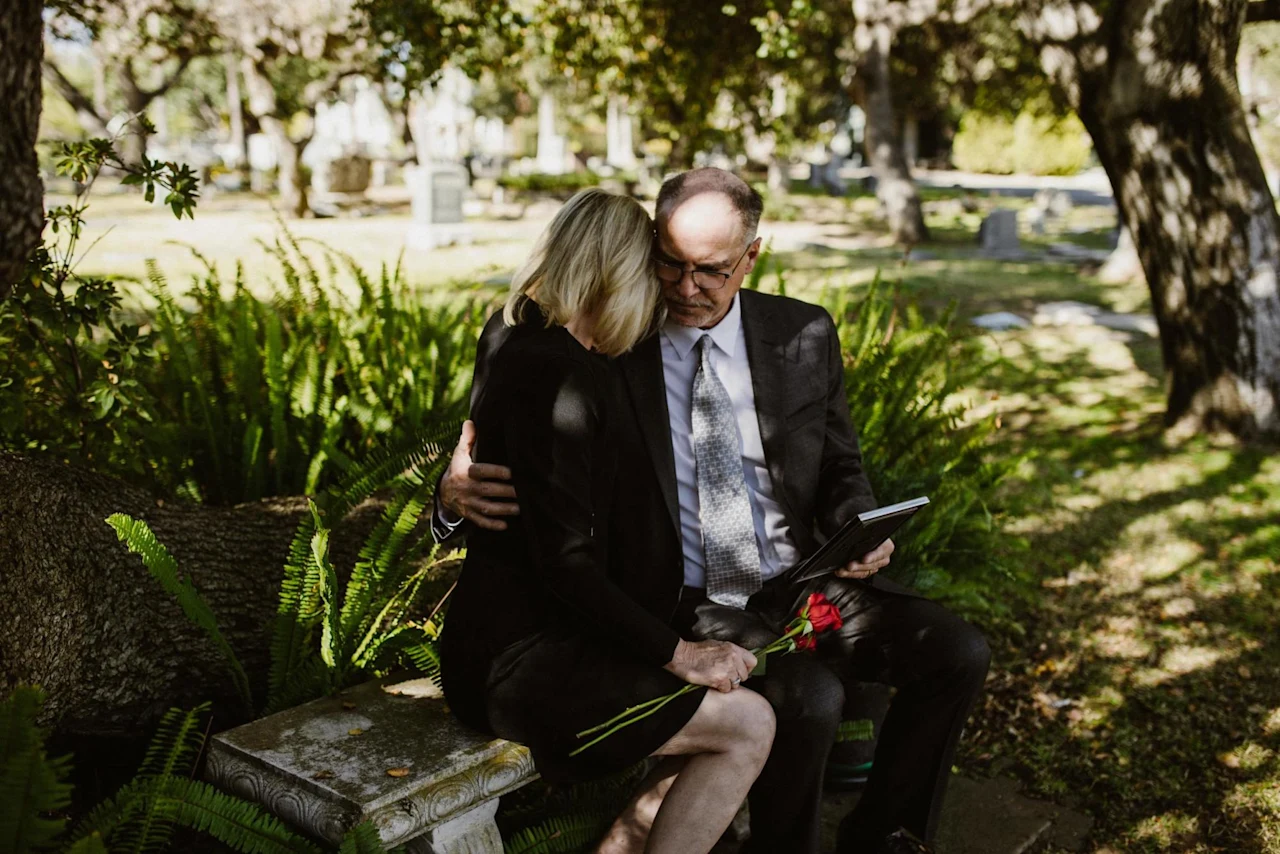 What happens when you die, represented by a couple embracing at a funeral service.
