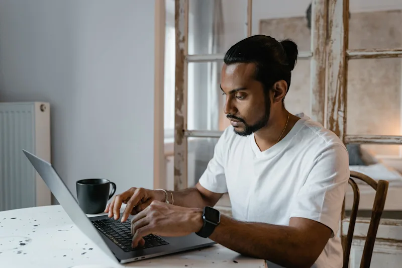 Man researching on his computer about cremation planning.