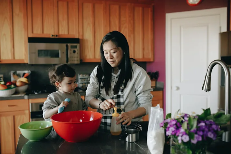 Mom with child in kitchen after learning how to avoid ancillary probate in Florida.