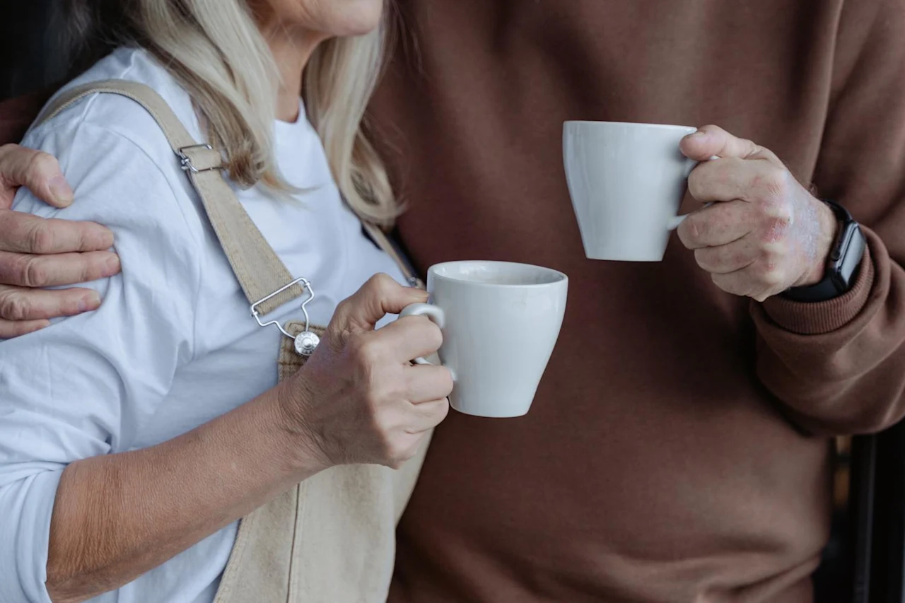 Couple holding coffee mugs while discussing what you need to know about heggstad petitions.