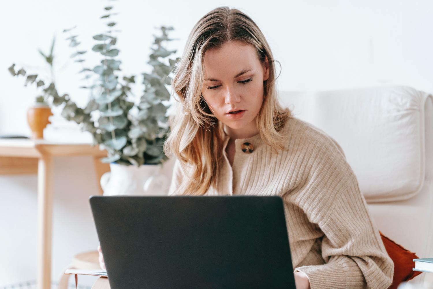 Woman on laptop researching what you need to know about ancillary probate in California.