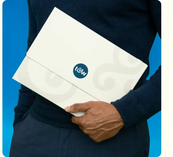 Person holding a Trust & Will estate plan folder