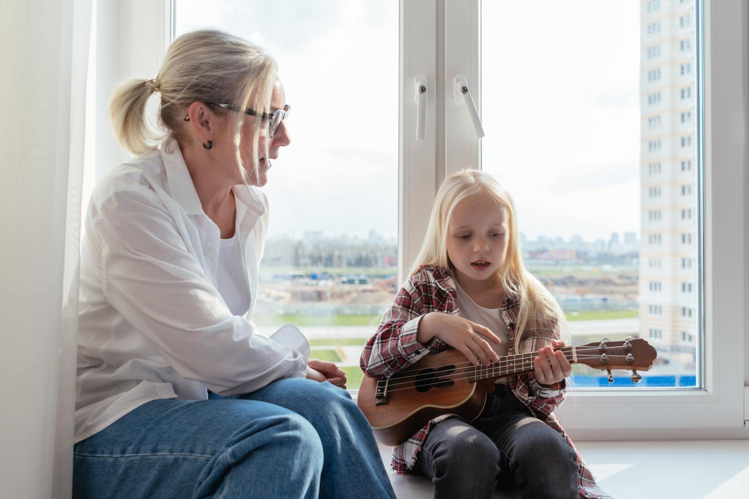 Woman with granddaughter playing ukulele after learning about letter of instruction and why you need it.