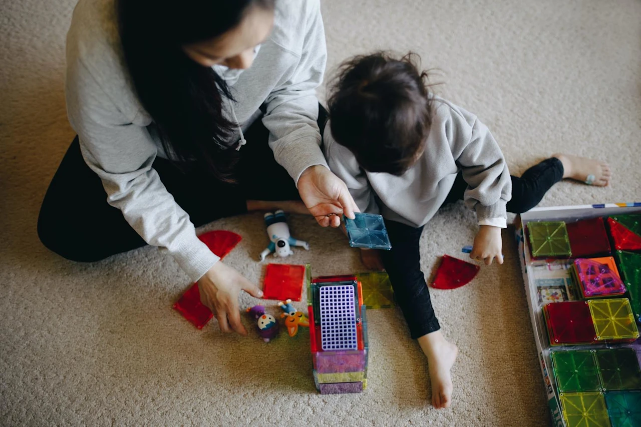 Woman playing with son after learning how filial responsibility laws can affect her.