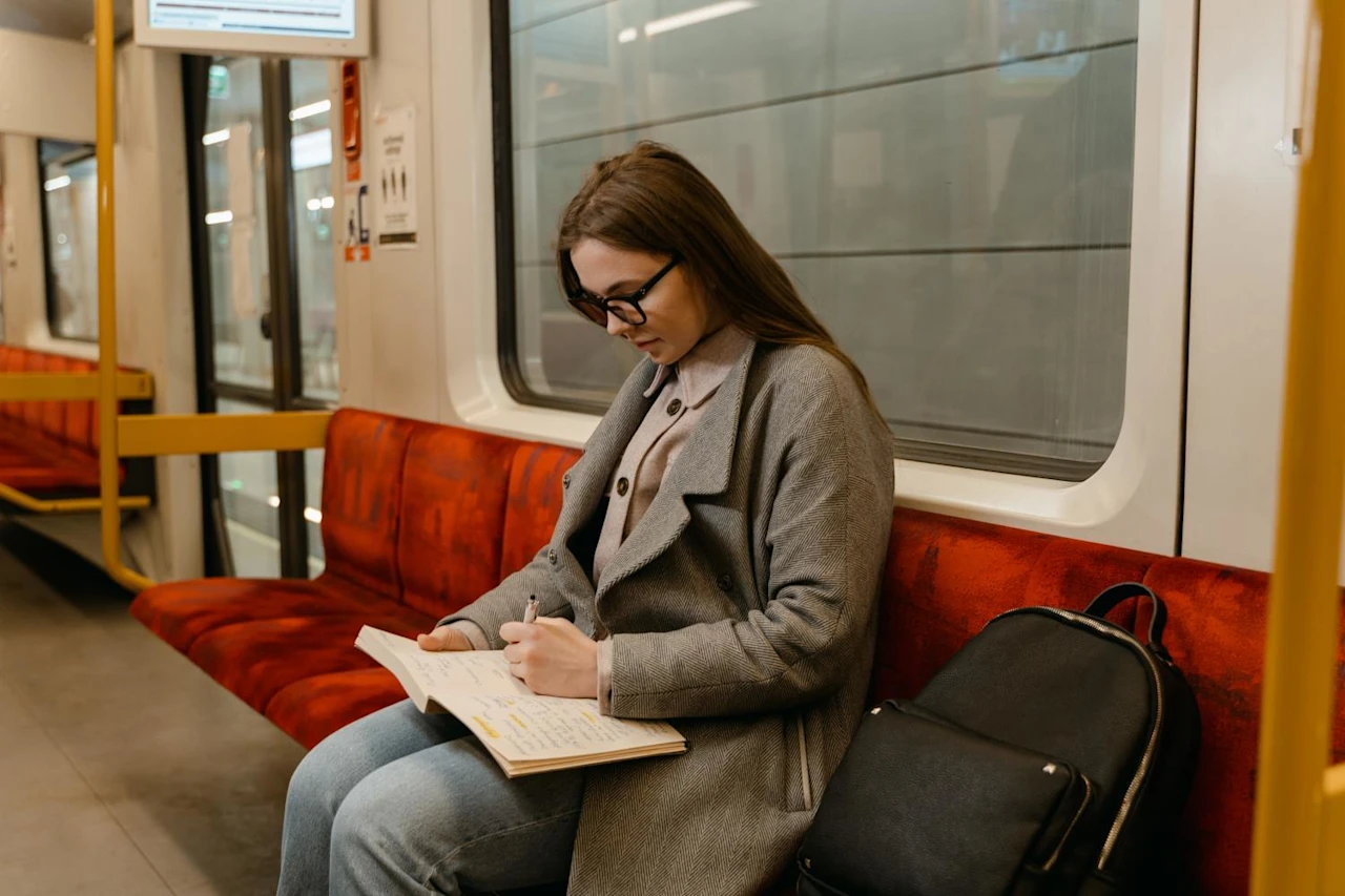 Woman on train listening to podcast about what is escheat?