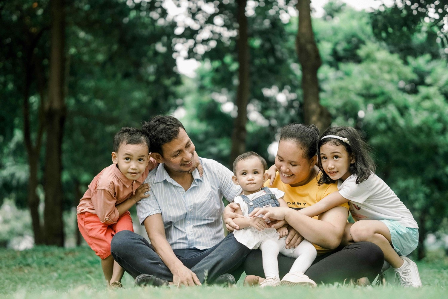 A family hugging one another after creating their family trust.