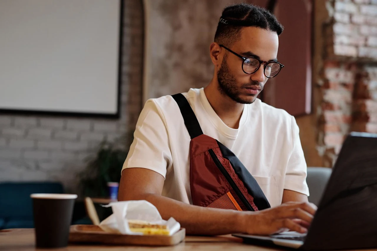 Man on laptop researching how to find a life insurance policy.
