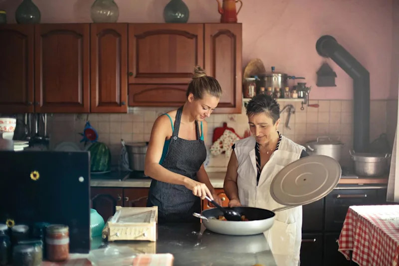 Mother cooking with daughter while having a conversation about wills.